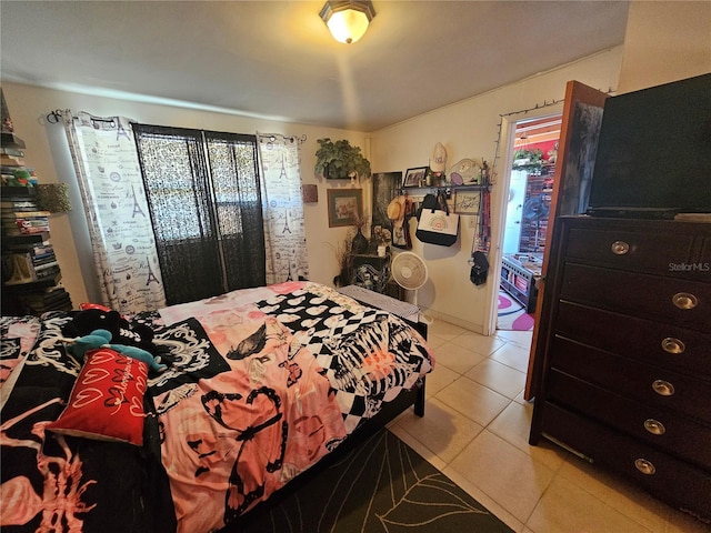 bedroom with multiple windows and light tile patterned floors