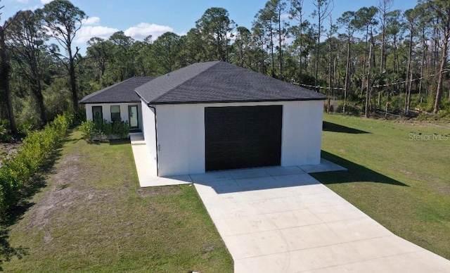 view of outdoor structure with a garage and a yard