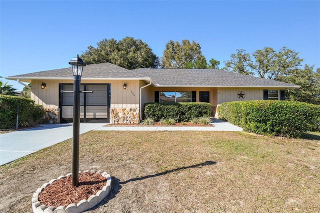 single story home featuring a garage and a front yard