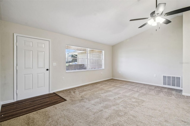 unfurnished room with lofted ceiling, ceiling fan, and carpet flooring