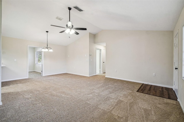 unfurnished room featuring lofted ceiling, carpet floors, and ceiling fan with notable chandelier