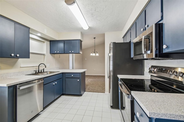 kitchen with appliances with stainless steel finishes, sink, hanging light fixtures, blue cabinetry, and a textured ceiling