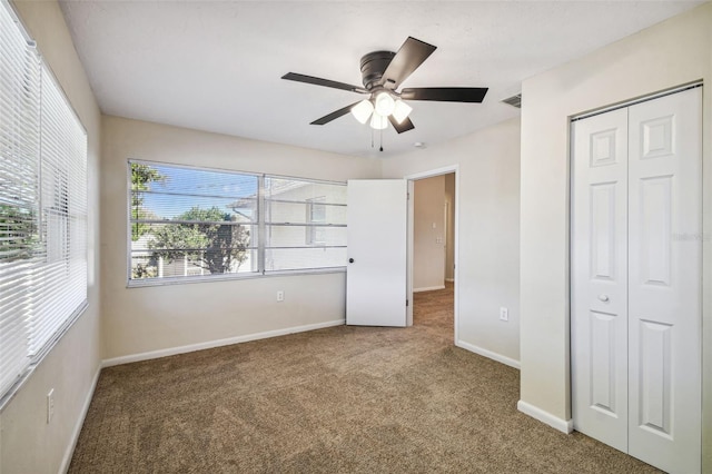 unfurnished bedroom featuring carpet flooring, ceiling fan, and a closet