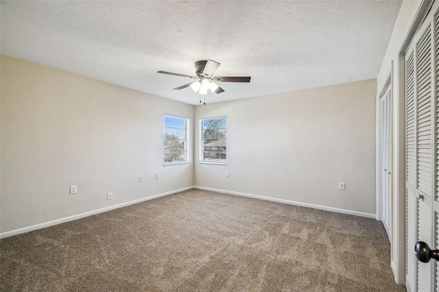 unfurnished bedroom with ceiling fan, carpet flooring, and a textured ceiling