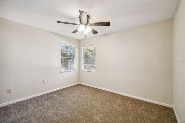 carpeted empty room featuring ceiling fan