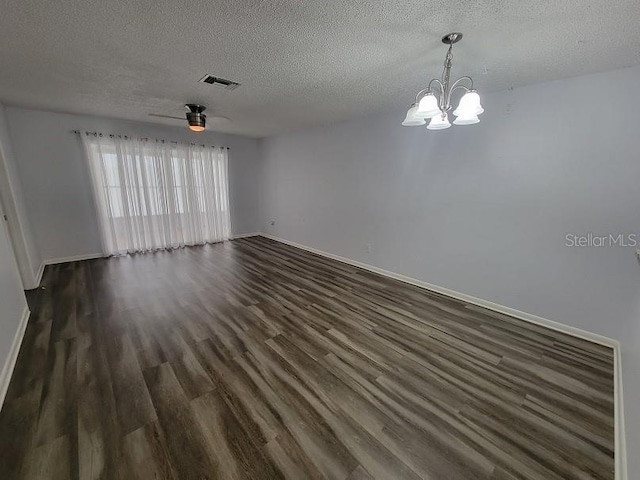 unfurnished room featuring dark wood-type flooring, ceiling fan with notable chandelier, and a textured ceiling