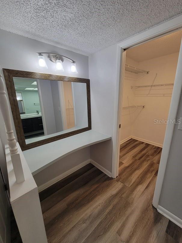 bathroom with vanity, hardwood / wood-style floors, and a textured ceiling