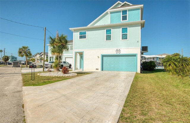 view of front of property featuring a garage and a front lawn