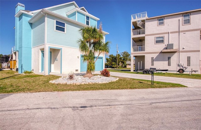 view of front of property with a front lawn and a garage