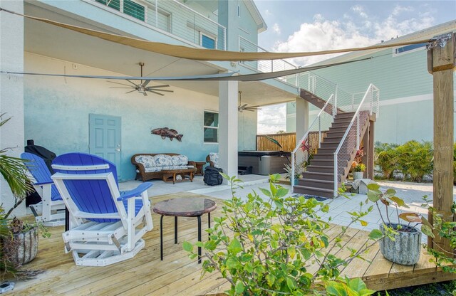 exterior space featuring an outdoor hangout area, ceiling fan, a deck, and a hot tub