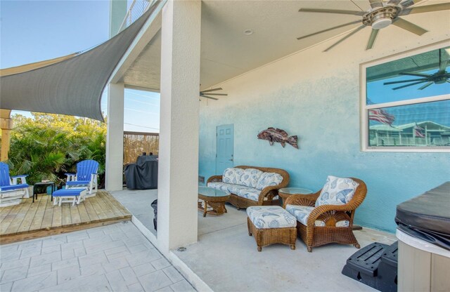 view of patio with a deck, an outdoor living space, and ceiling fan