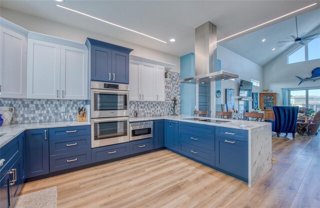 kitchen featuring white cabinetry, kitchen peninsula, light wood-type flooring, stainless steel appliances, and island range hood