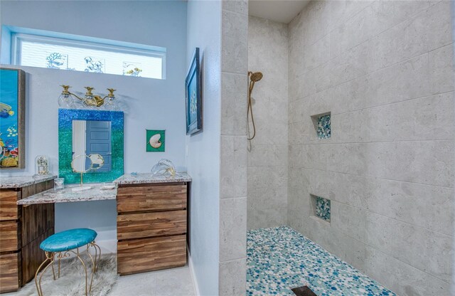 bathroom with plenty of natural light, vanity, and tiled shower