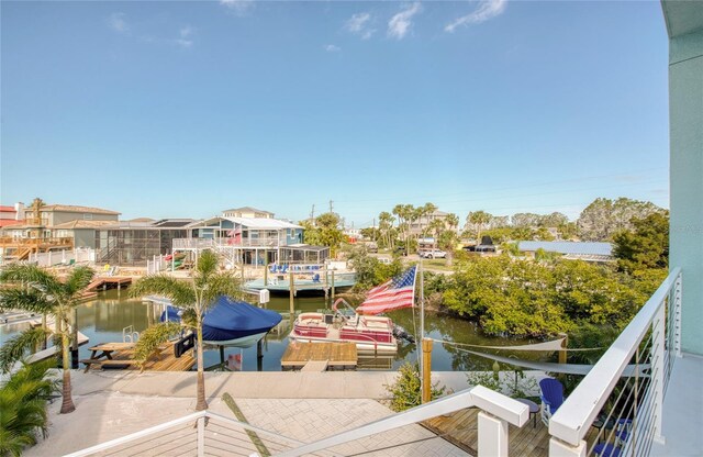 balcony featuring a dock and a water view