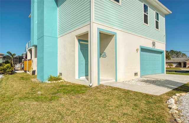 6613 Josie Ln, Hudson, FL 34667 - rear view of house with an attached garage, a yard, and stucco siding