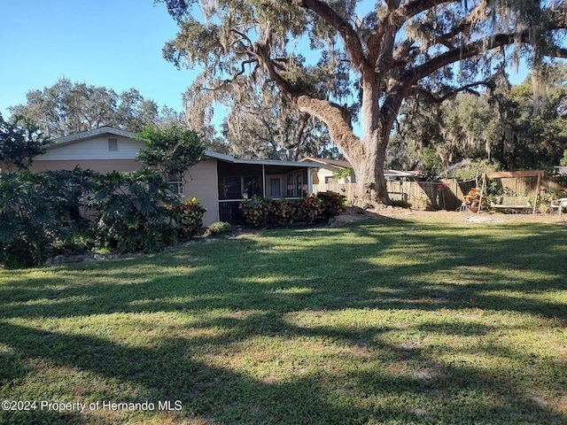 view of yard with a sunroom