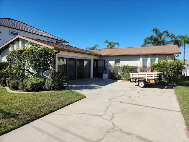 ranch-style house with a front lawn