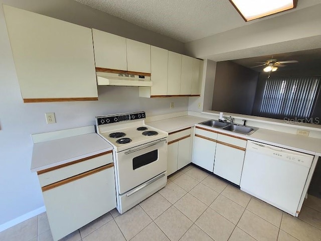 kitchen with white appliances, sink, light tile patterned flooring, a textured ceiling, and white cabinets