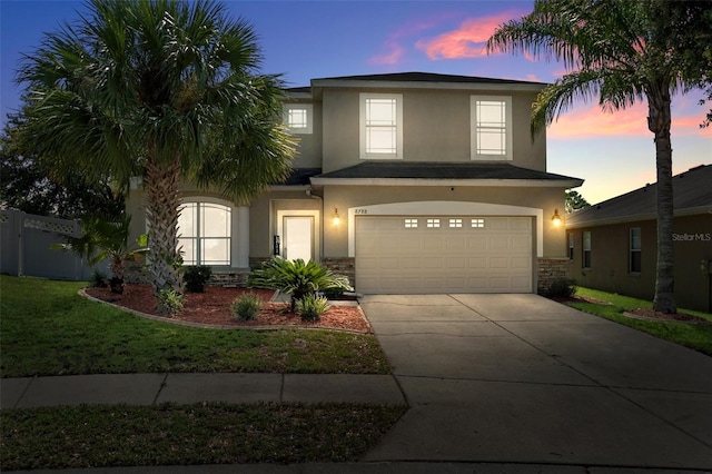 view of front of home featuring a garage and a lawn