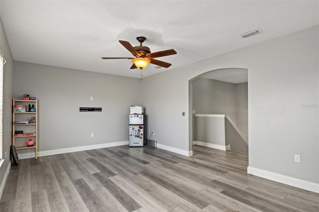 empty room featuring ceiling fan and light hardwood / wood-style flooring