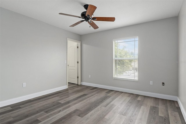 spare room with wood-type flooring and ceiling fan