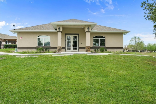 prairie-style home with french doors and a front yard