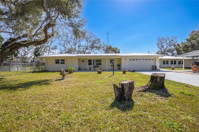 ranch-style house with a garage and a front lawn