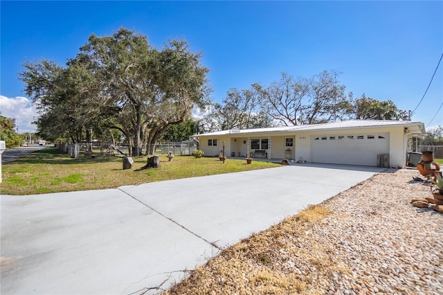 single story home featuring a garage and a front yard