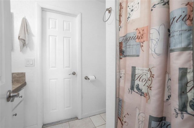 bathroom with tile patterned flooring, vanity, and curtained shower