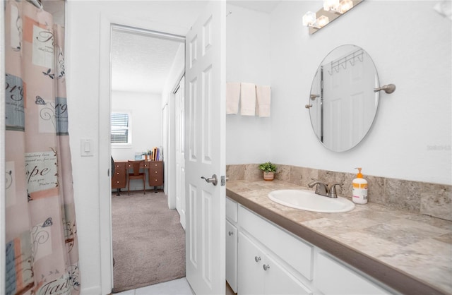 bathroom featuring vanity and a textured ceiling