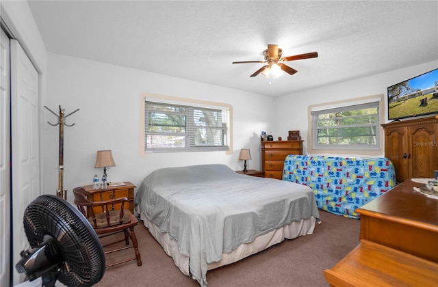 bedroom with carpet floors, a textured ceiling, ceiling fan, and a closet