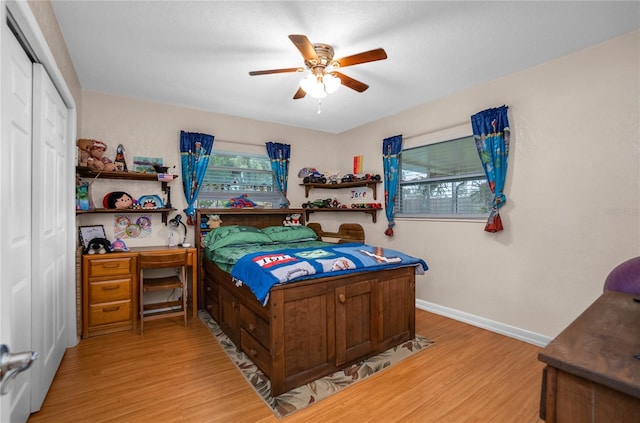 bedroom featuring a closet, ceiling fan, and light wood-type flooring