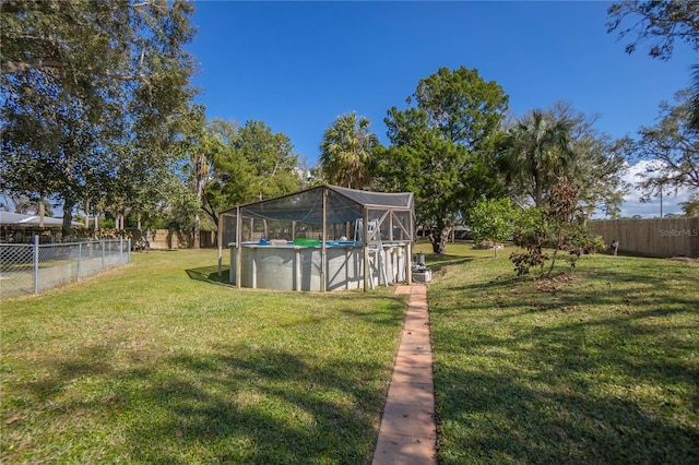 view of yard with a fenced in pool