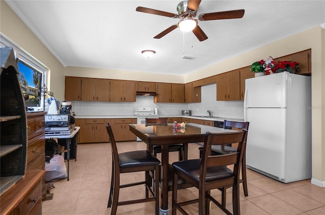 kitchen with sink, white appliances, crown molding, tasteful backsplash, and light tile patterned flooring