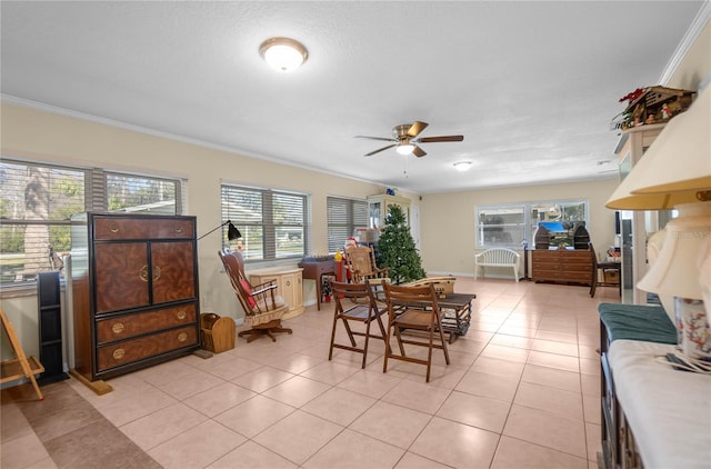 tiled dining room with crown molding and ceiling fan