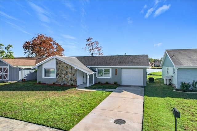 single story home featuring a garage and a front lawn