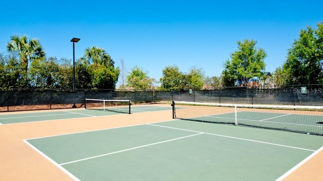 view of tennis court with basketball hoop