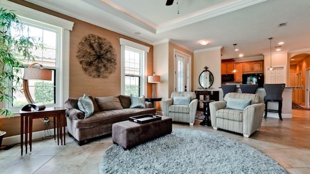 interior space with plenty of natural light, ornamental molding, and ceiling fan