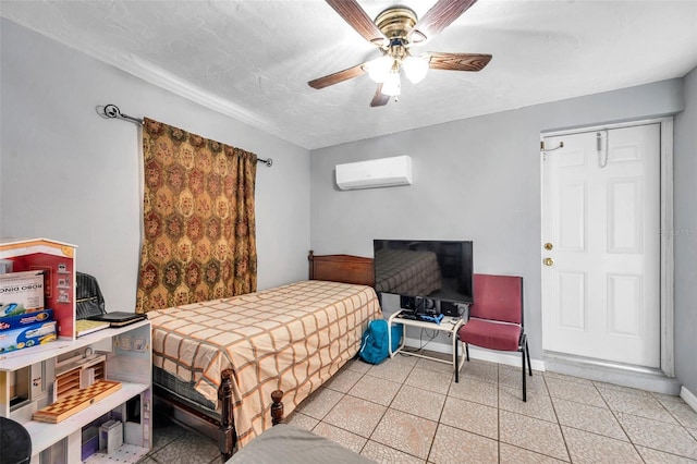 bedroom featuring a ceiling fan, baseboards, a textured ceiling, and a wall mounted air conditioner
