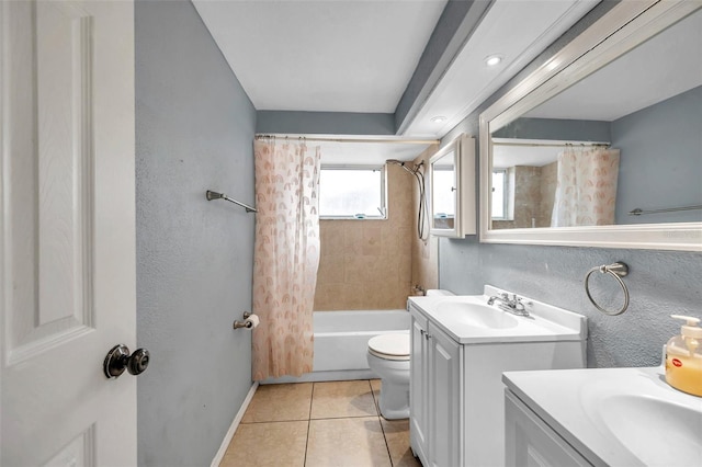 bathroom featuring toilet, vanity, baseboards, tile patterned floors, and shower / bath combo with shower curtain