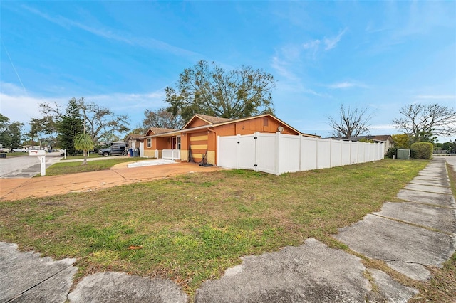view of property exterior with a yard and fence