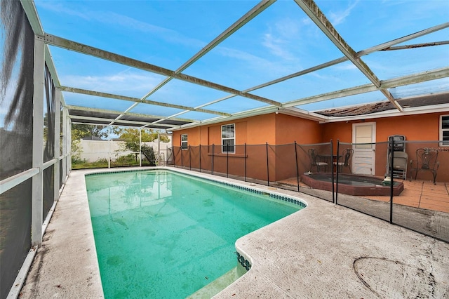 view of pool featuring glass enclosure, a patio area, and a fenced in pool