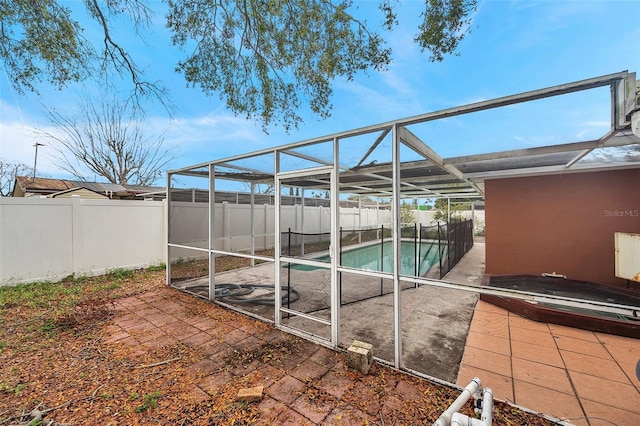 exterior space featuring a lanai, a fenced backyard, a jacuzzi, and a fenced in pool