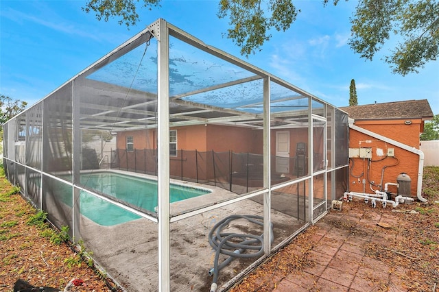 view of swimming pool with a lanai, a patio area, a fenced backyard, and a fenced in pool