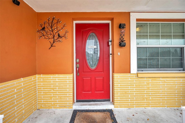 property entrance with brick siding