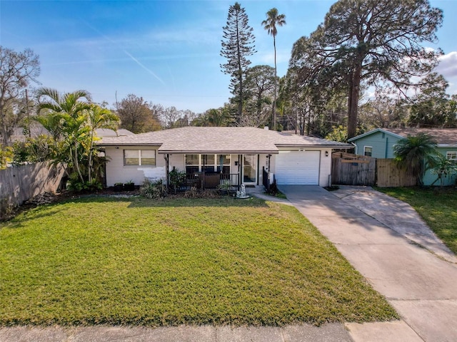 ranch-style house featuring a garage, covered porch, and a front lawn