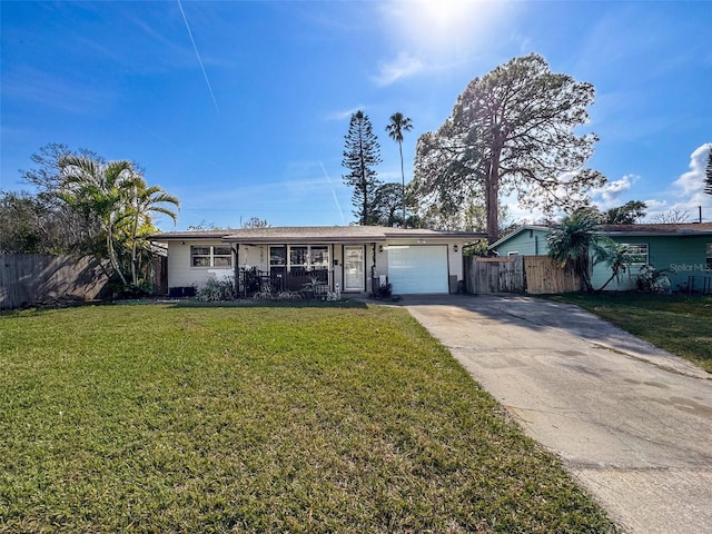 ranch-style house with a garage, covered porch, and a front lawn