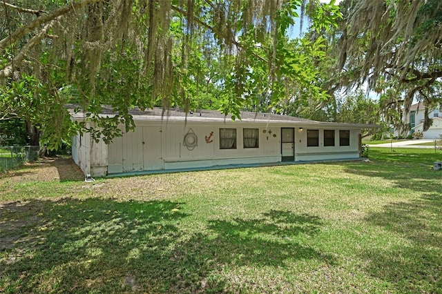 back of house with a lawn