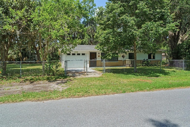 view of front of house with a garage and a front lawn