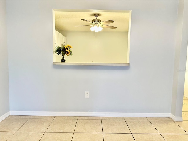 spare room with light tile patterned floors and ceiling fan